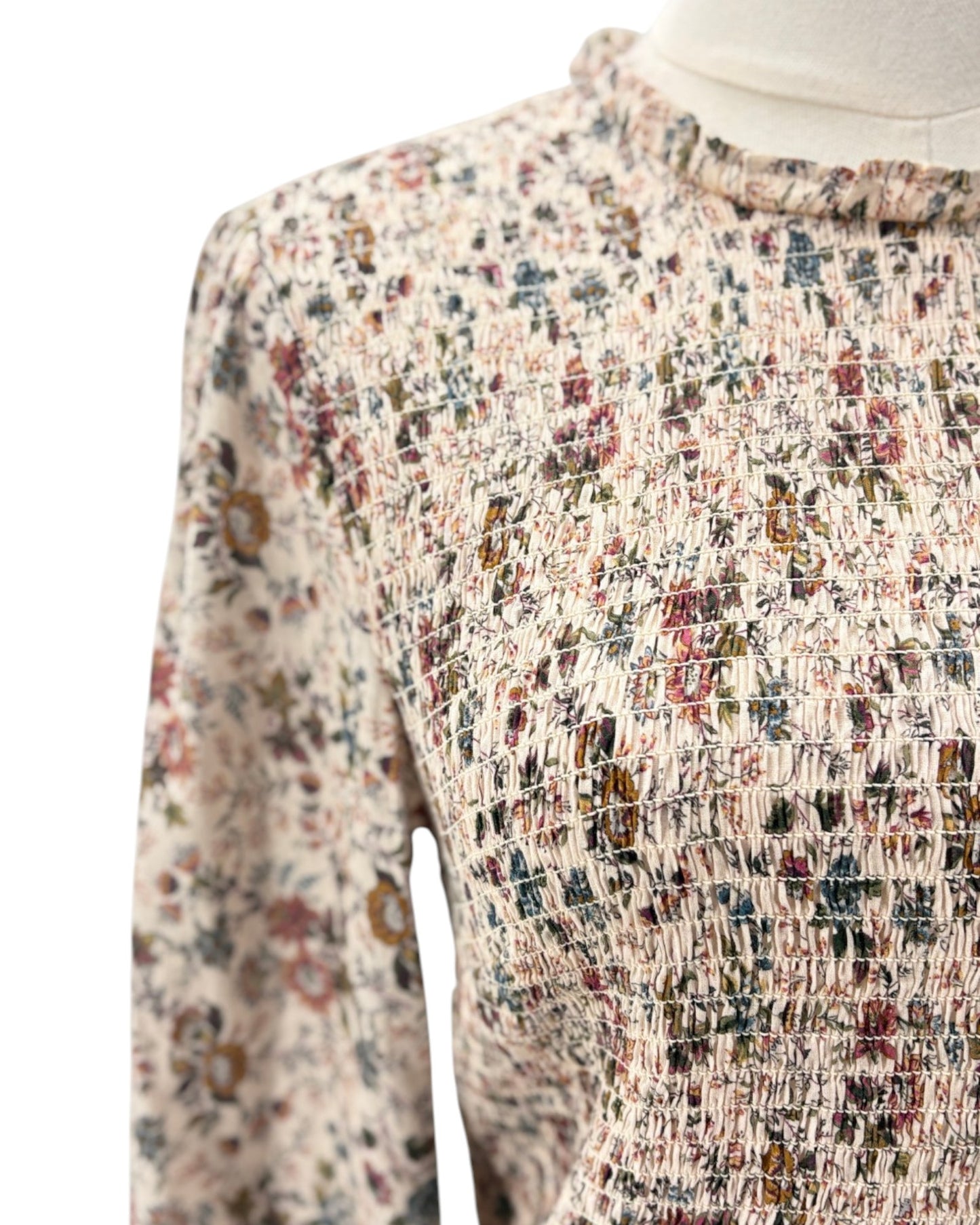Multicolored patterned garment on a mannequin against a white background