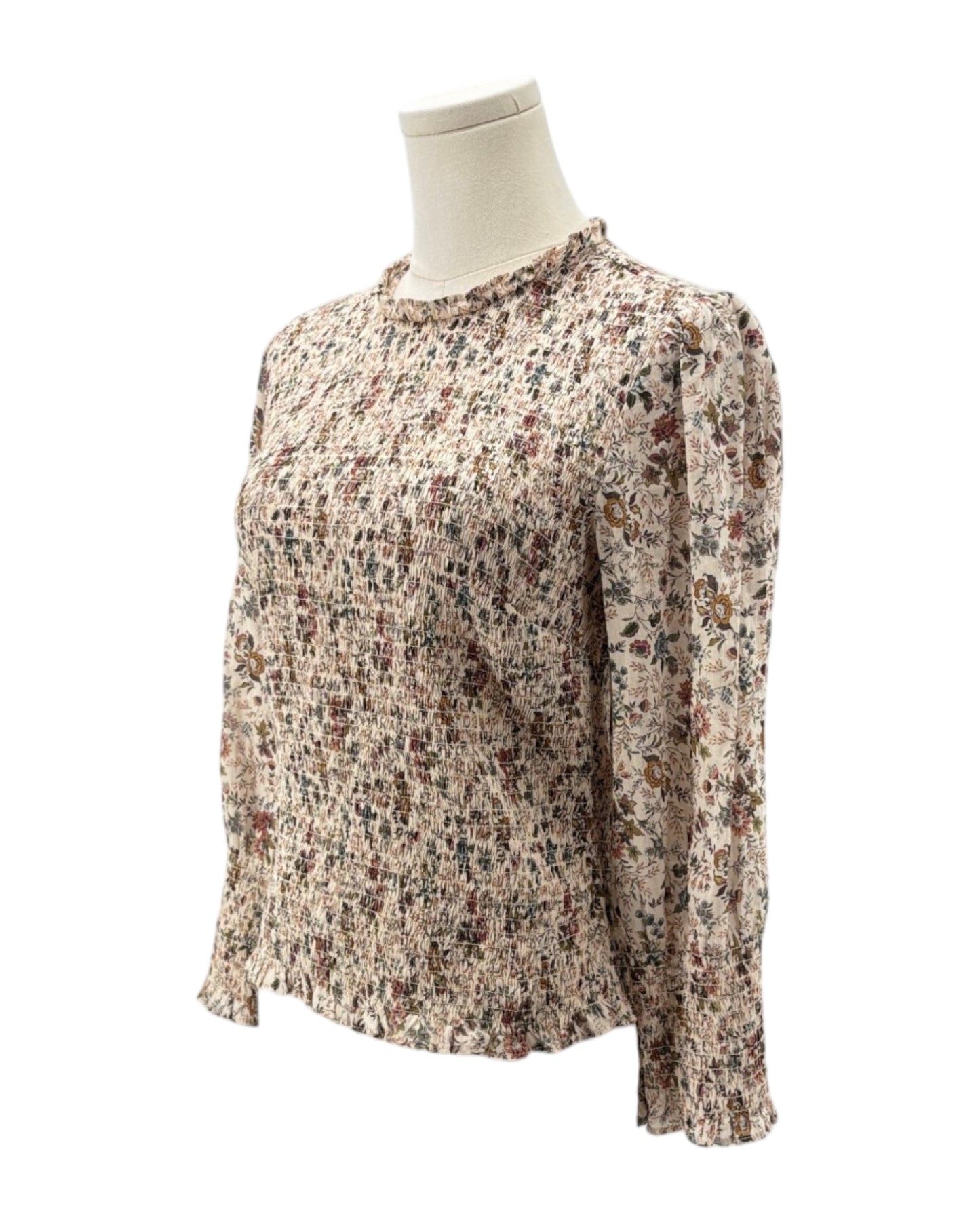 Floral patterned blouse on a mannequin against a white background