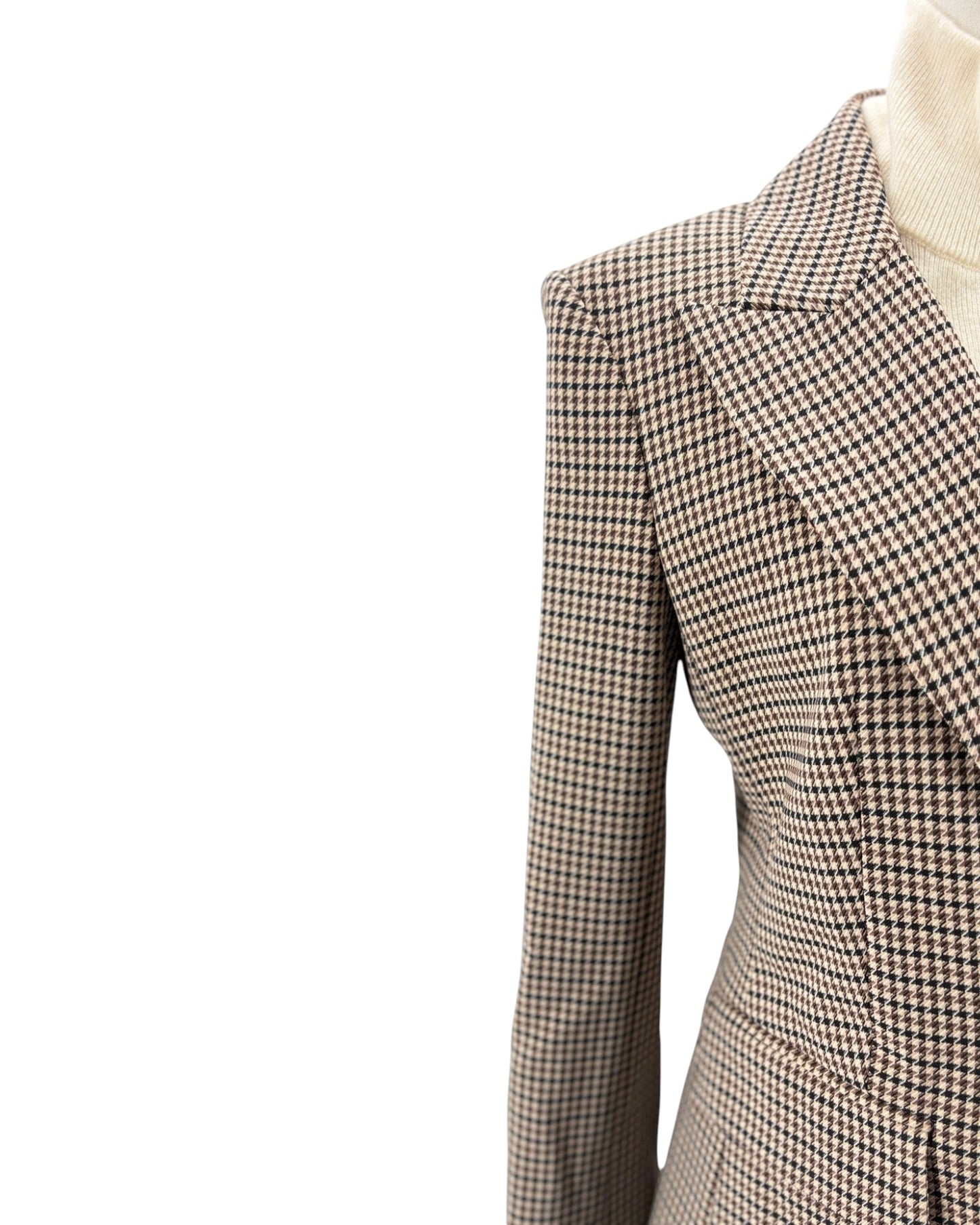 Houndstooth patterned blazer on a mannequin with a white background