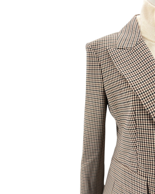 Houndstooth patterned blazer on a mannequin with a white background