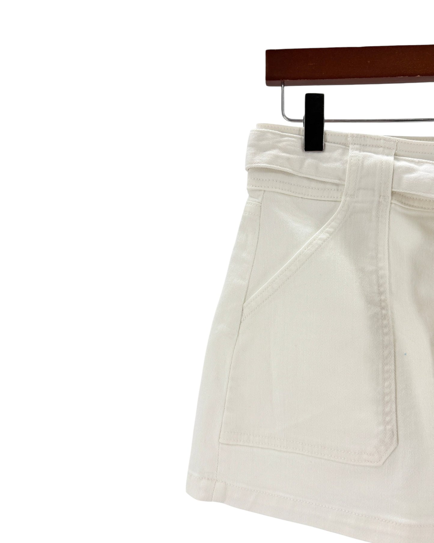 White pants on a hanger against a white background