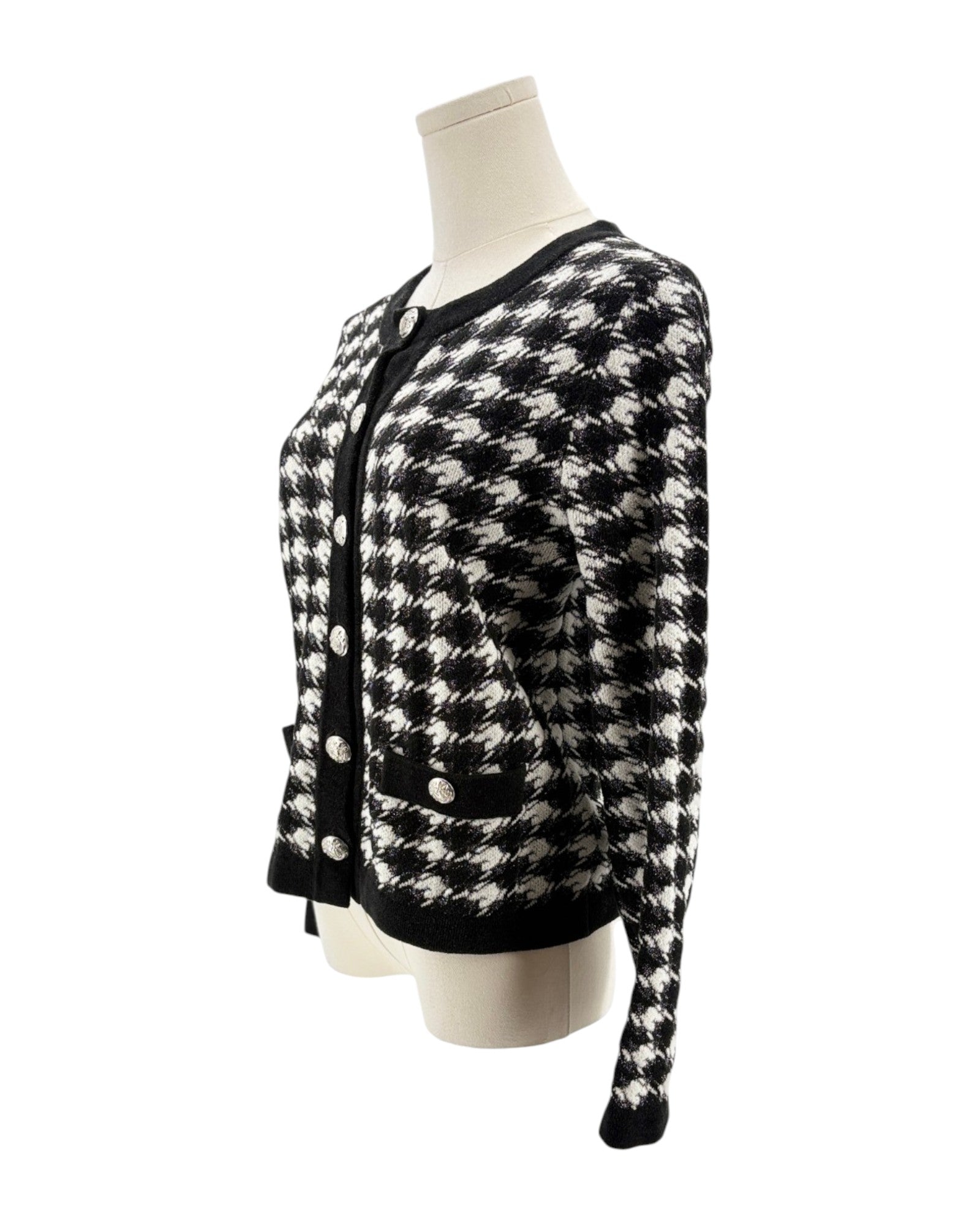 Black and white checkered cardigan on a mannequin against a white background