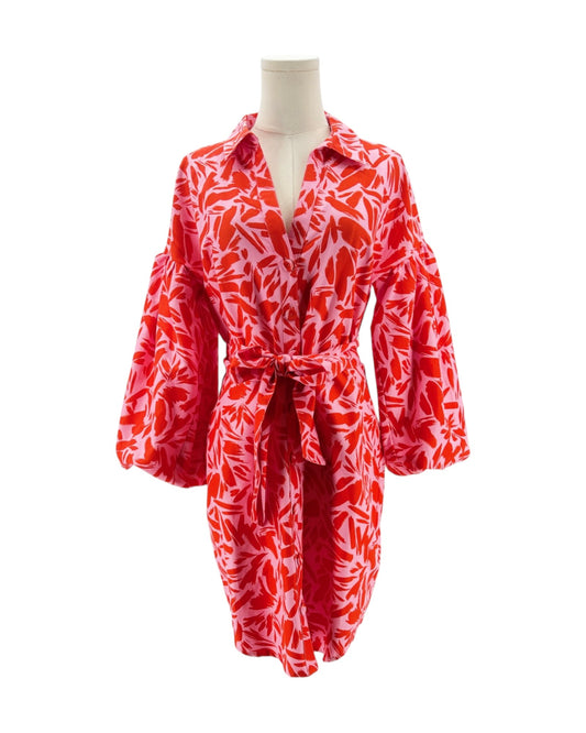 Red and white patterned dress on a mannequin against a white background