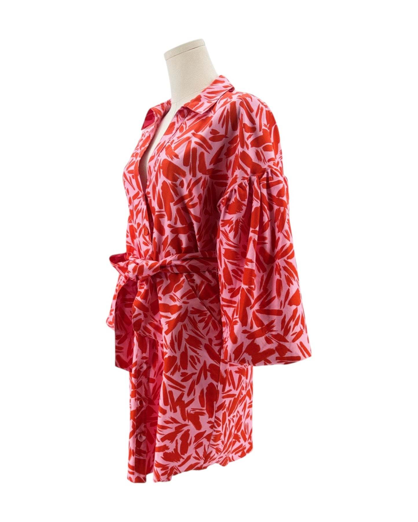 Red and white patterned robe on a mannequin against a white background