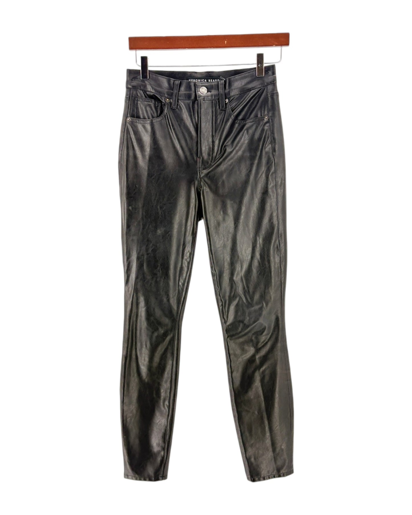 Black leather pants on a hanger against a white background