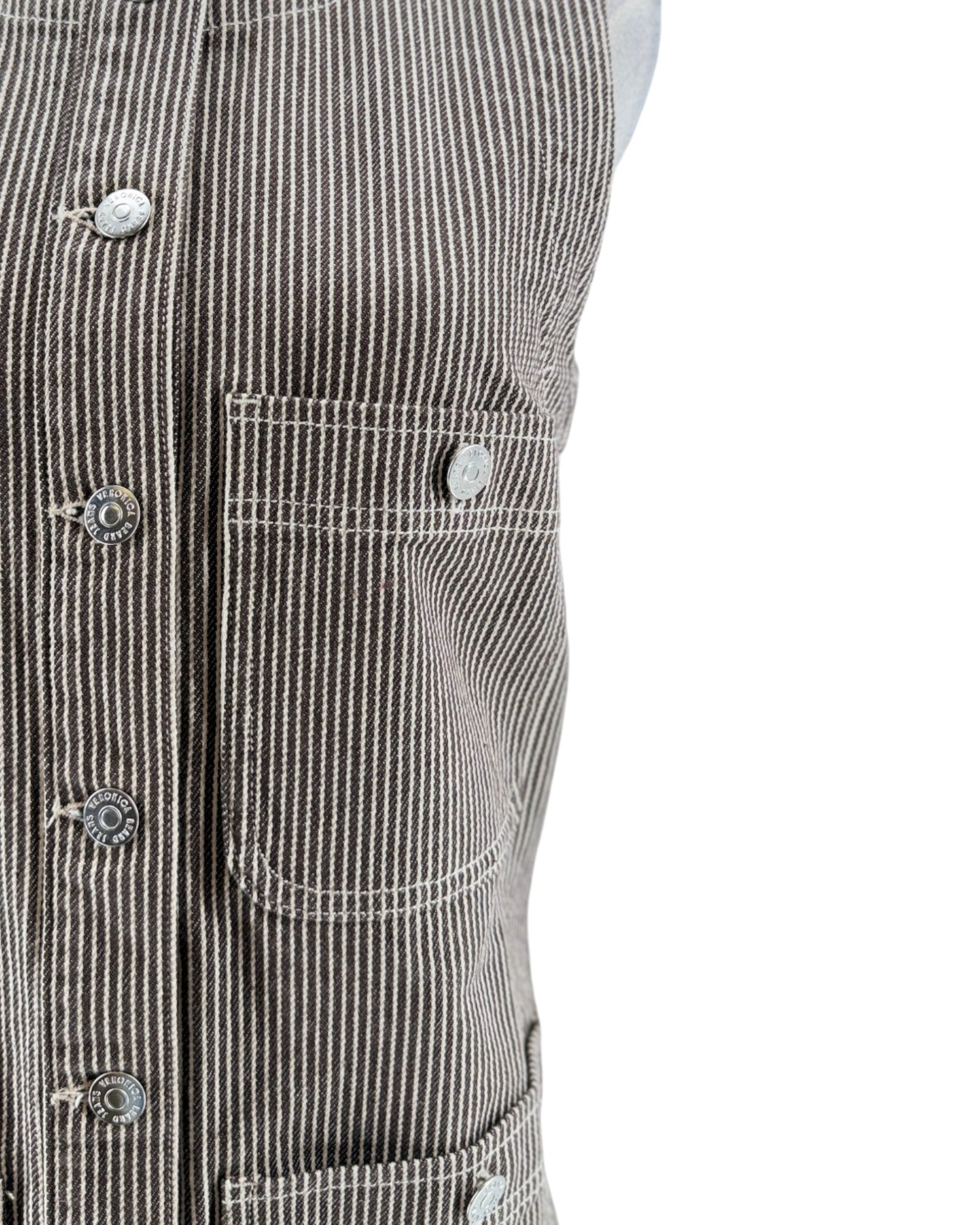 Close-up of a black and white striped jacket with button details on a white background