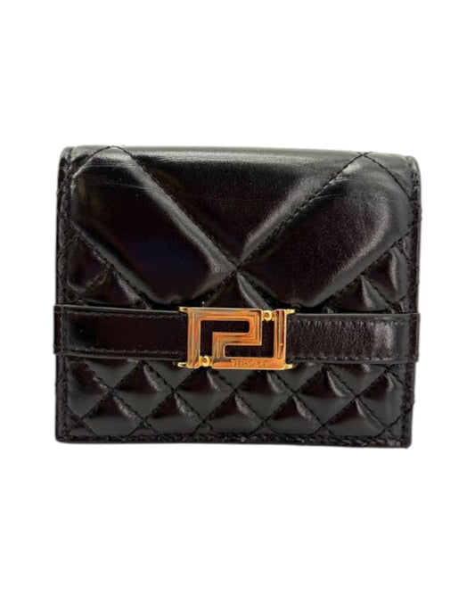 Black quilted wallet with a gold clasp on a white background
