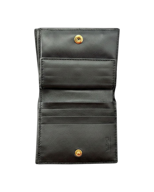 Black leather wallet with gold buttons on a white background