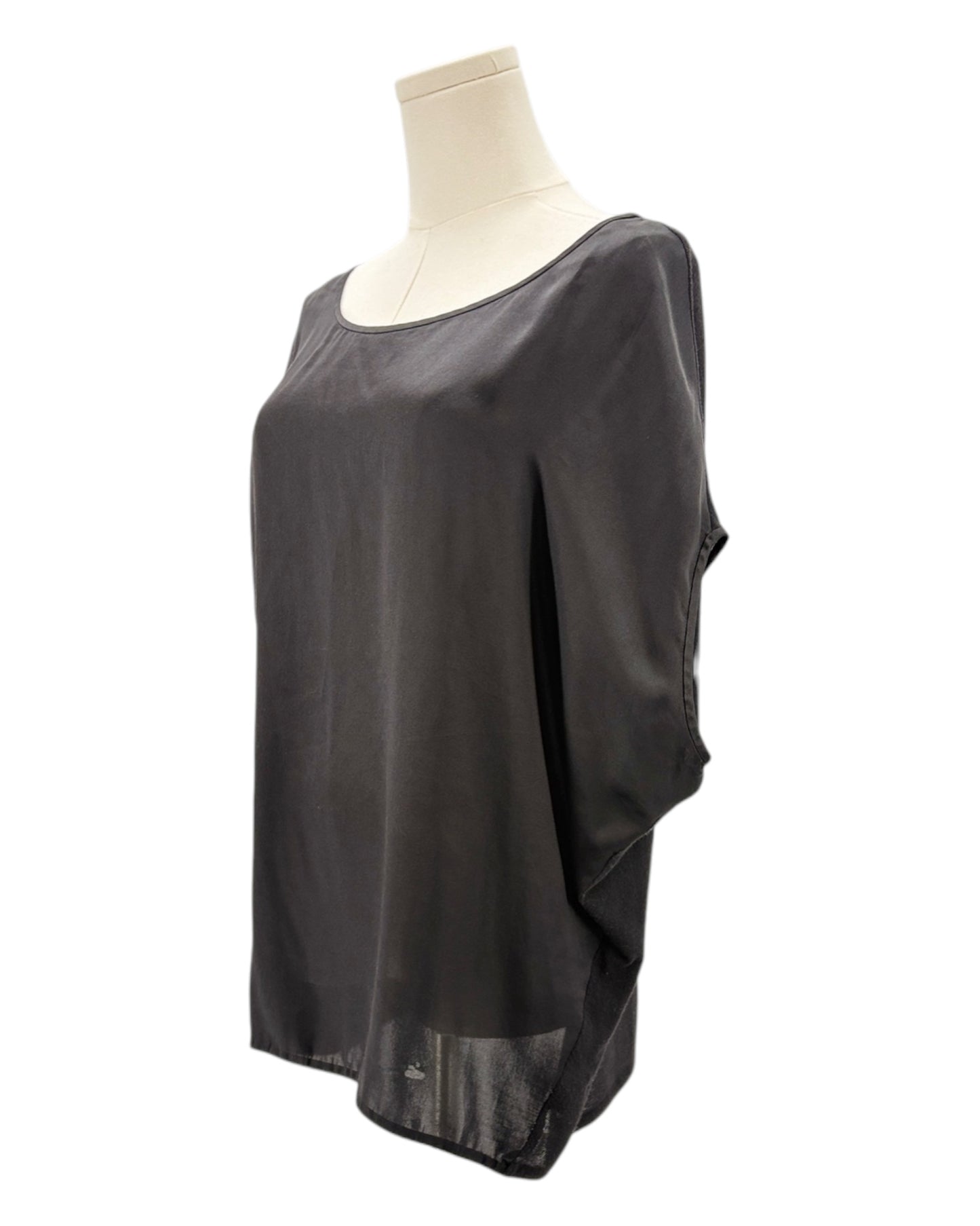 Black sheer top on a mannequin against a white background