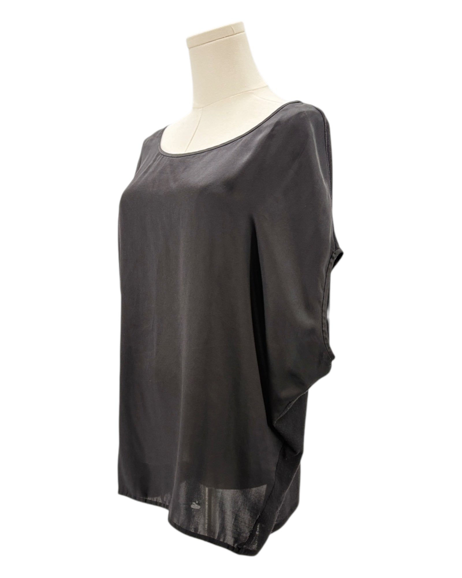 Black sheer top on a mannequin against a white background