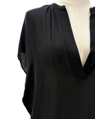 Black blouse on a mannequin with a white background