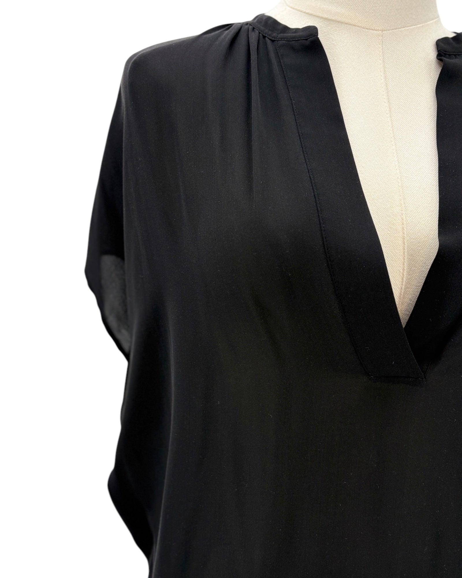 Black blouse on a mannequin with a white background