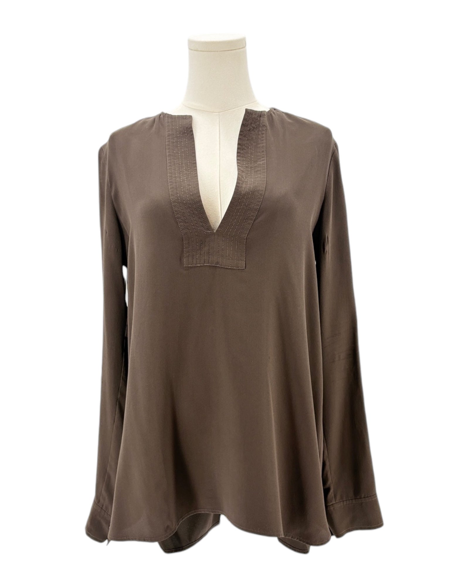 Brown blouse on a mannequin against a white background