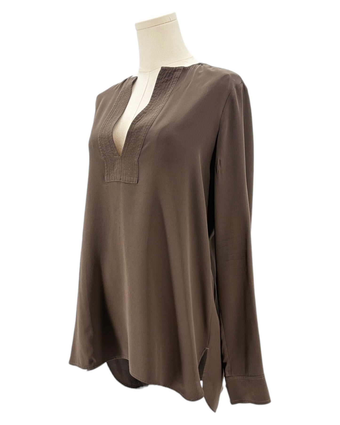 Brown blouse on a mannequin against a white background