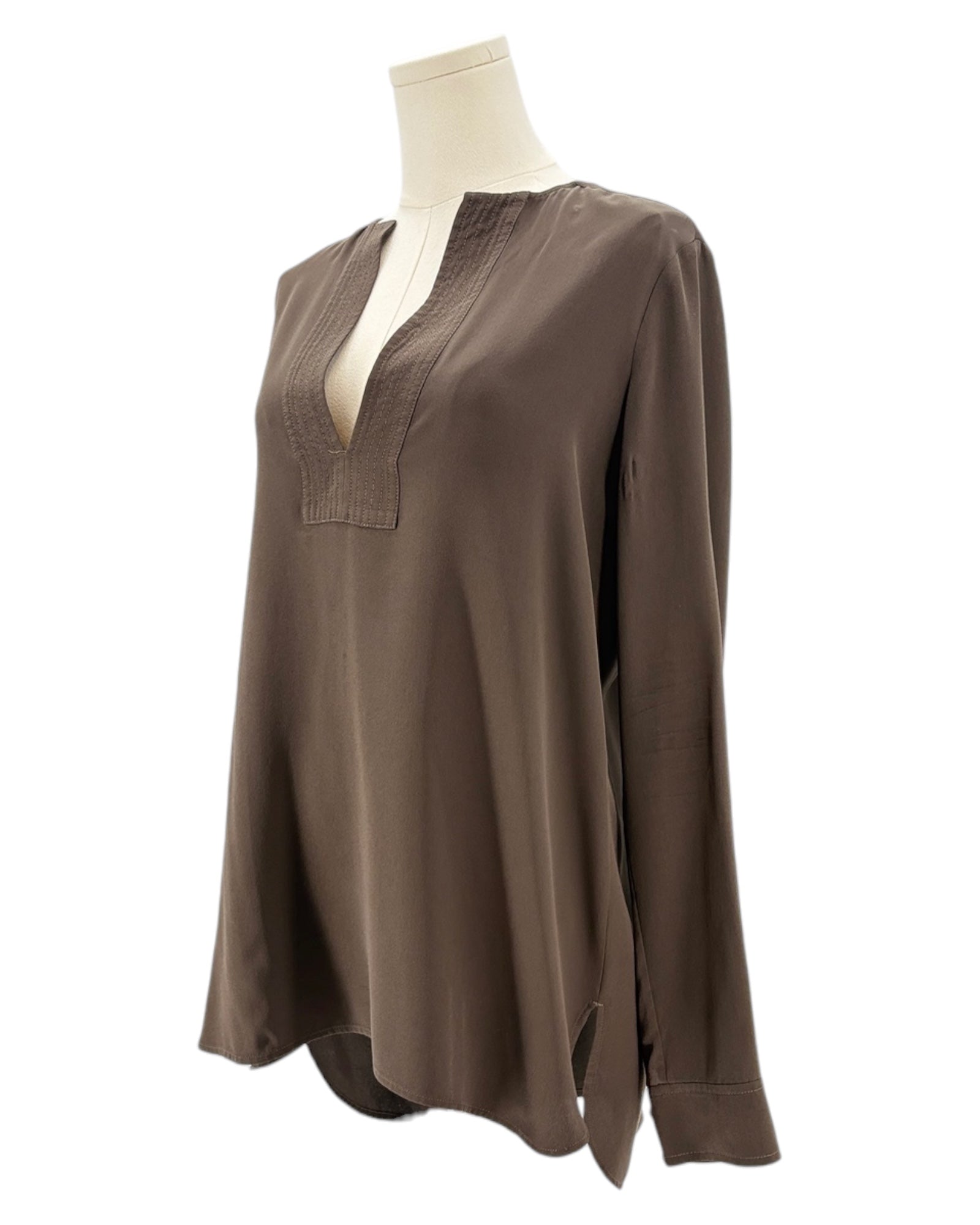 Brown blouse on a mannequin against a white background
