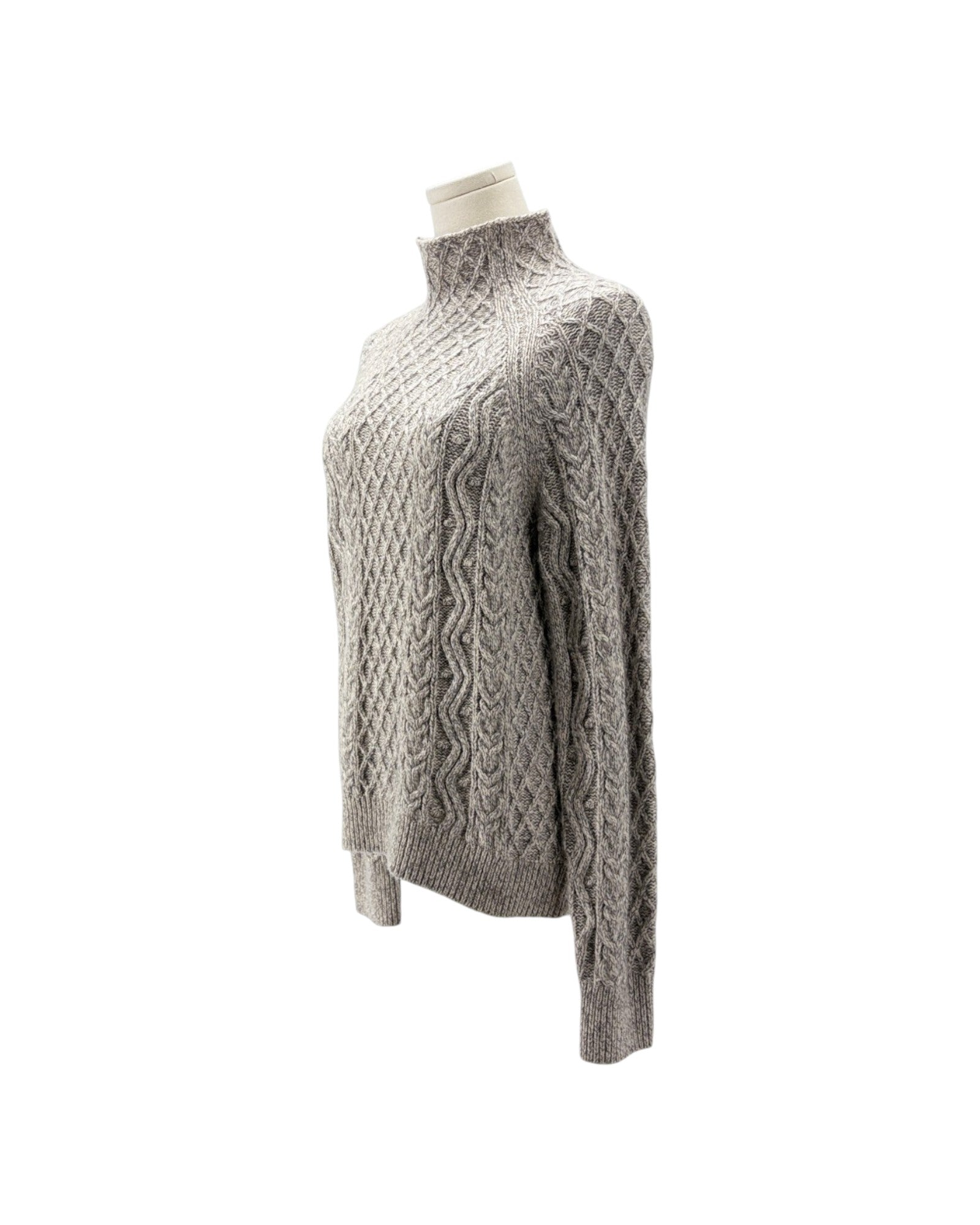 A light gray cable-knit mock neck sweater displayed on a cream mannequin torso against a plain white background.