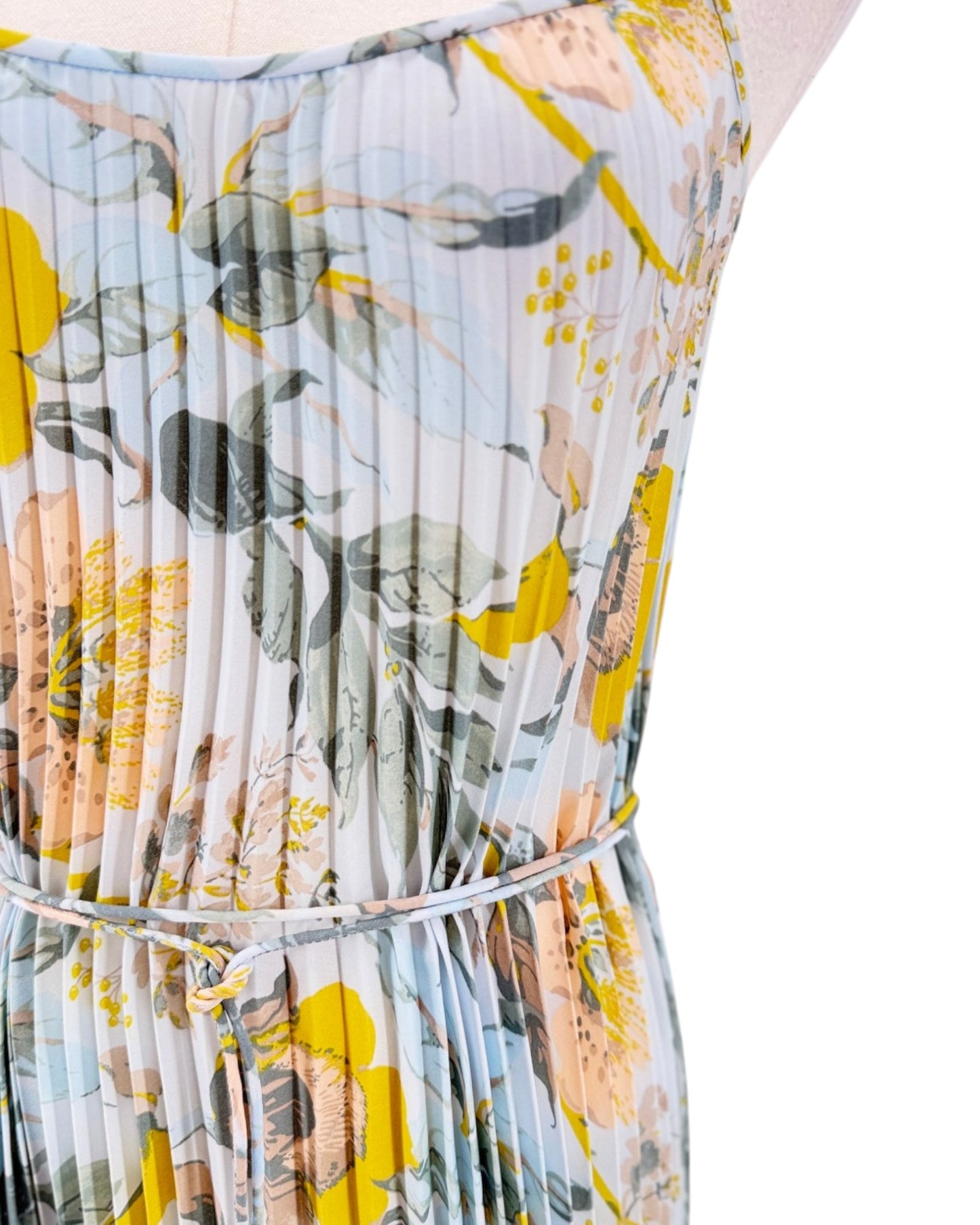Floral dress with yellow and green pattern on a white background