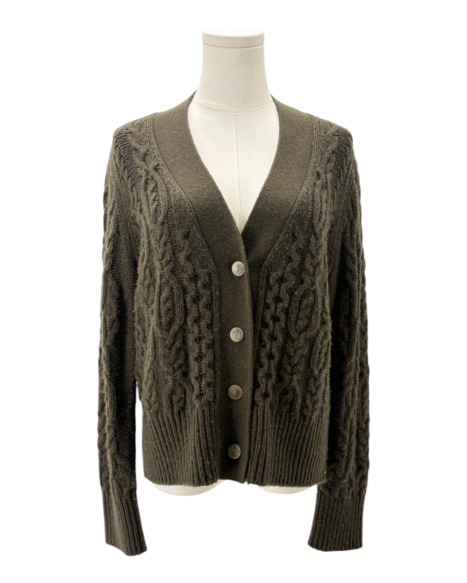 Brown cable knit cardigan on a mannequin against a white background