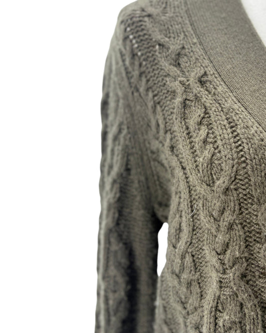 Close-up of a cable knit sweater on a white background