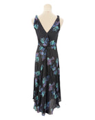 Black dress with colorful floral pattern on a mannequin against a white background