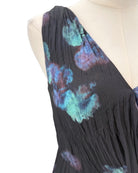 Black dress with colorful floral patterns on a mannequin against a white background