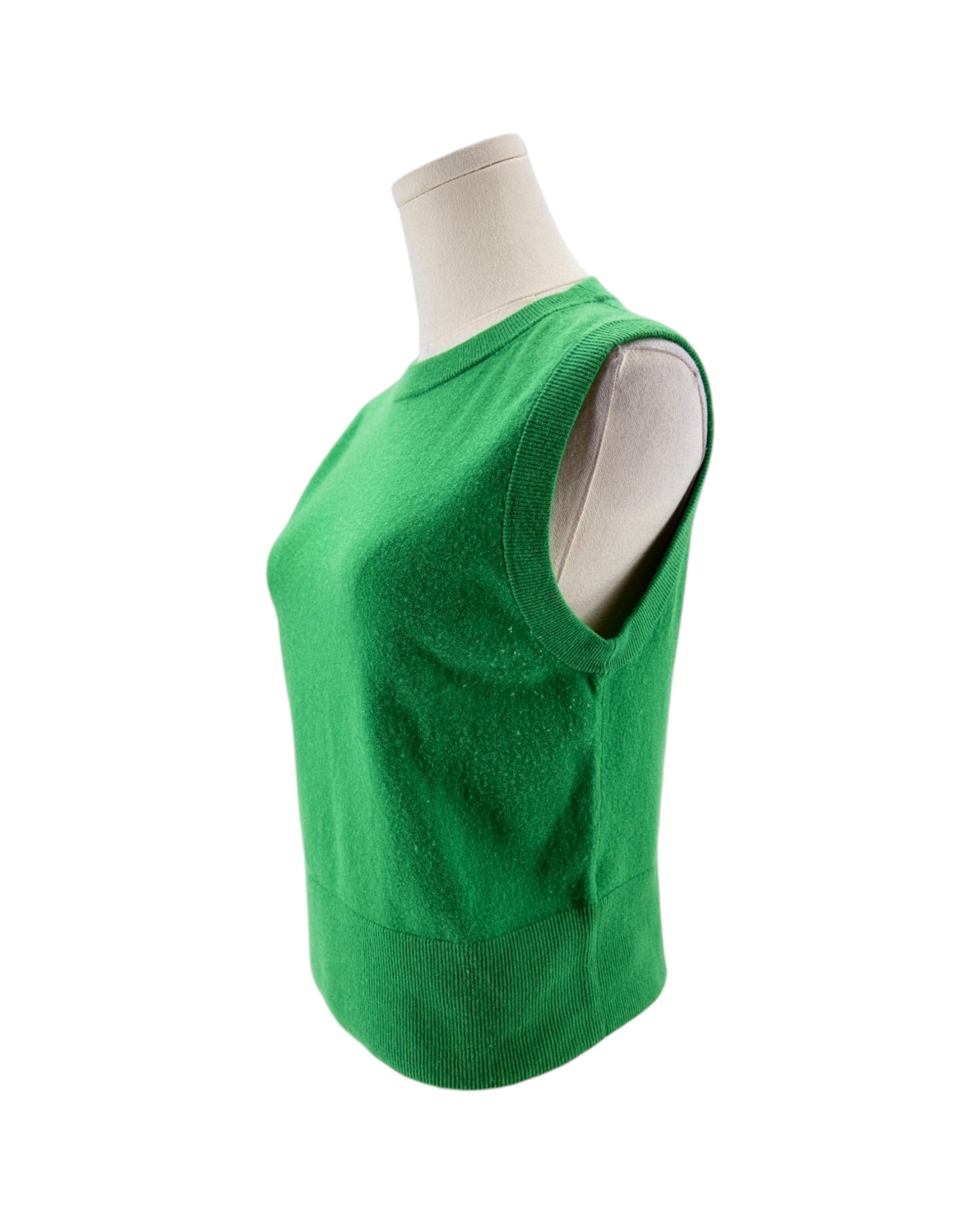 A bright green sleeveless knit sweater vest displayed on a white mannequin torso against a plain white background.