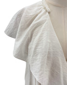 White textured fabric draped over a mannequin on a white background