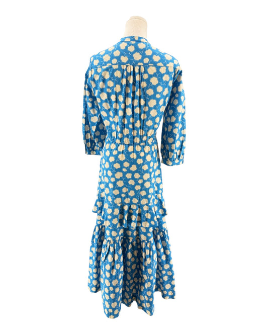 Blue dress with white polka dots on a mannequin against a white background