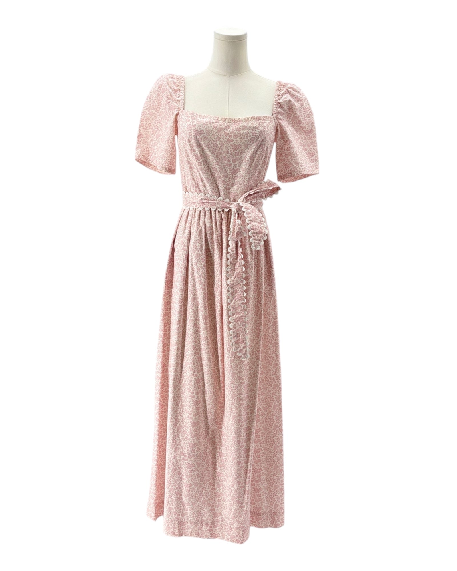 Pink dress on a mannequin against a white background