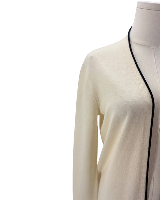 Cream cardigan with black trim on a mannequin against a white background