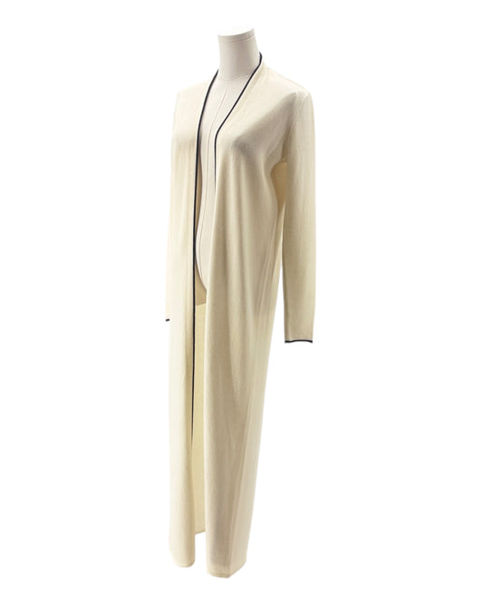 Long cream-colored dress with black trim on a mannequin against a white background