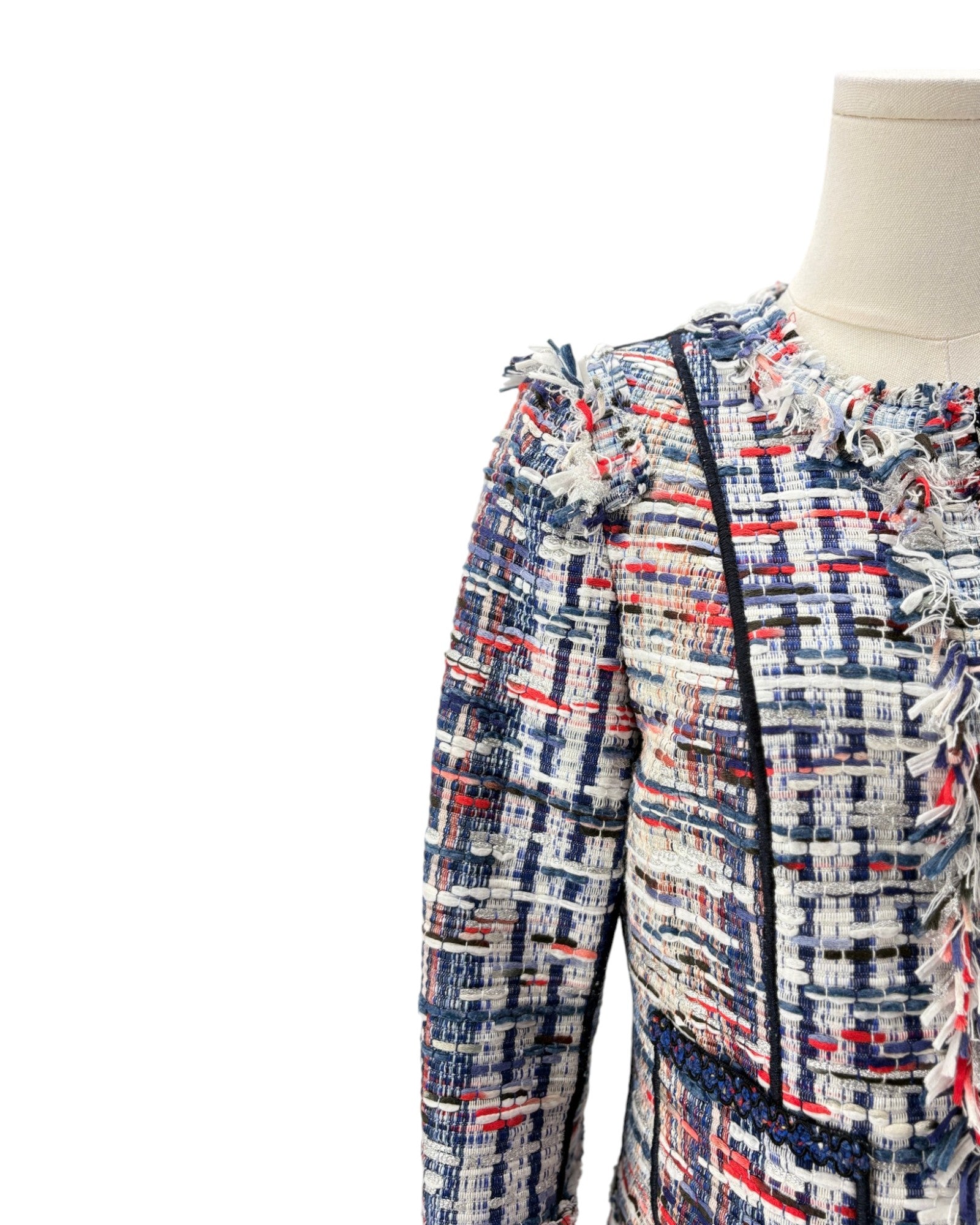 Multicolored patterned jacket on a mannequin against a white background