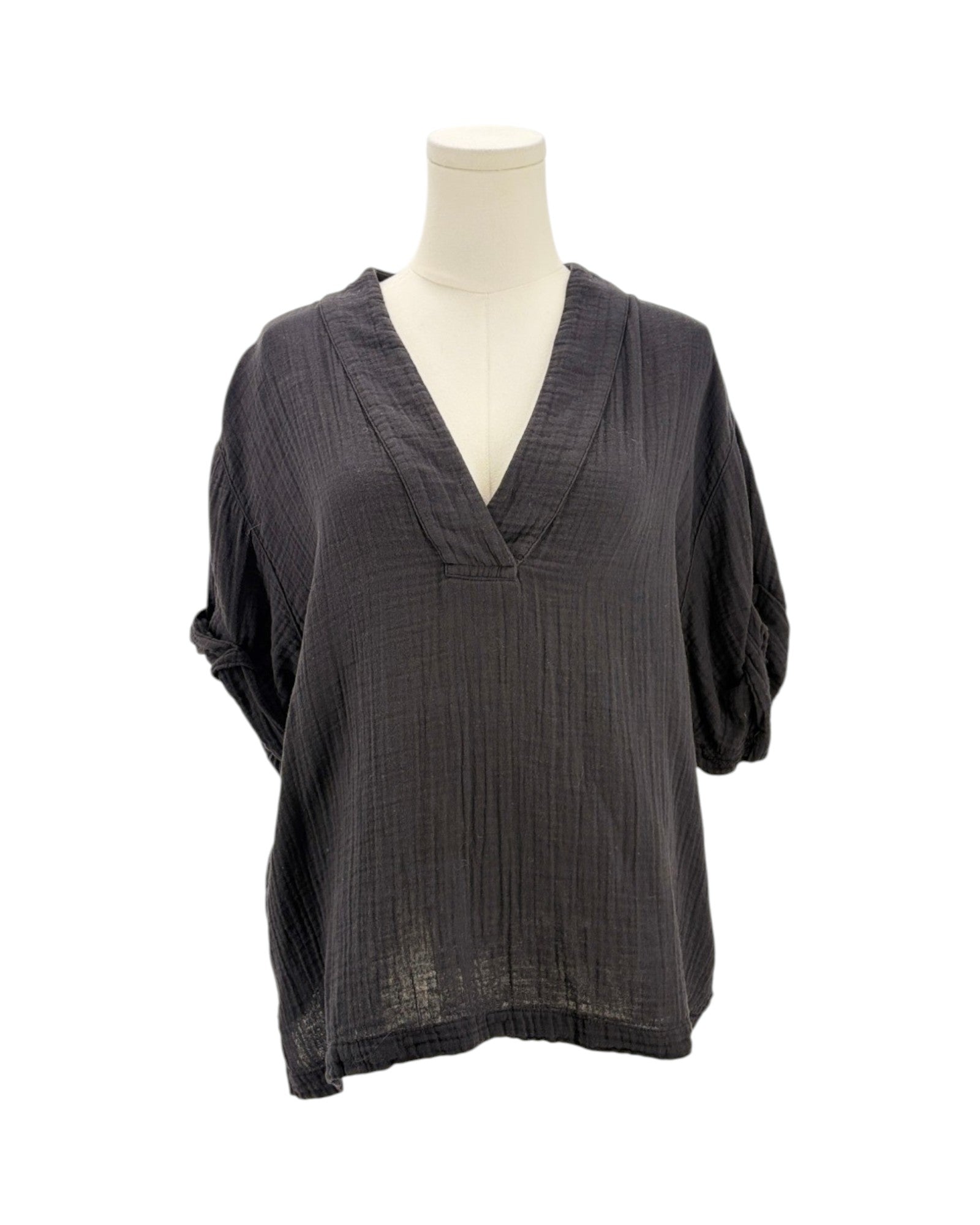 black textured top on a mannequin against a white background