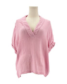 Pink top on a mannequin against a white background