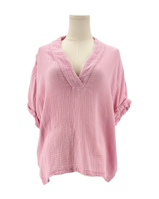 Pink top on a mannequin against a white background