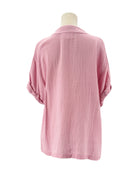 Pink textured shirt on a mannequin against a white background