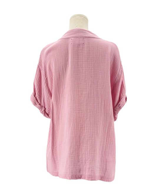 Pink textured shirt on a mannequin against a white background