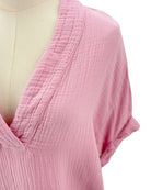 Close-up of a pink textured top on a mannequin with a white background