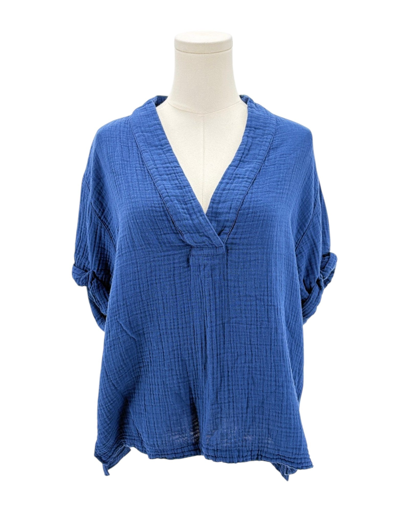 Blue textured blouse on a mannequin against a white background