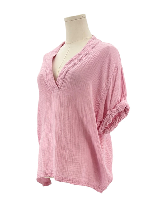 Pink textured blouse on a mannequin against a white background