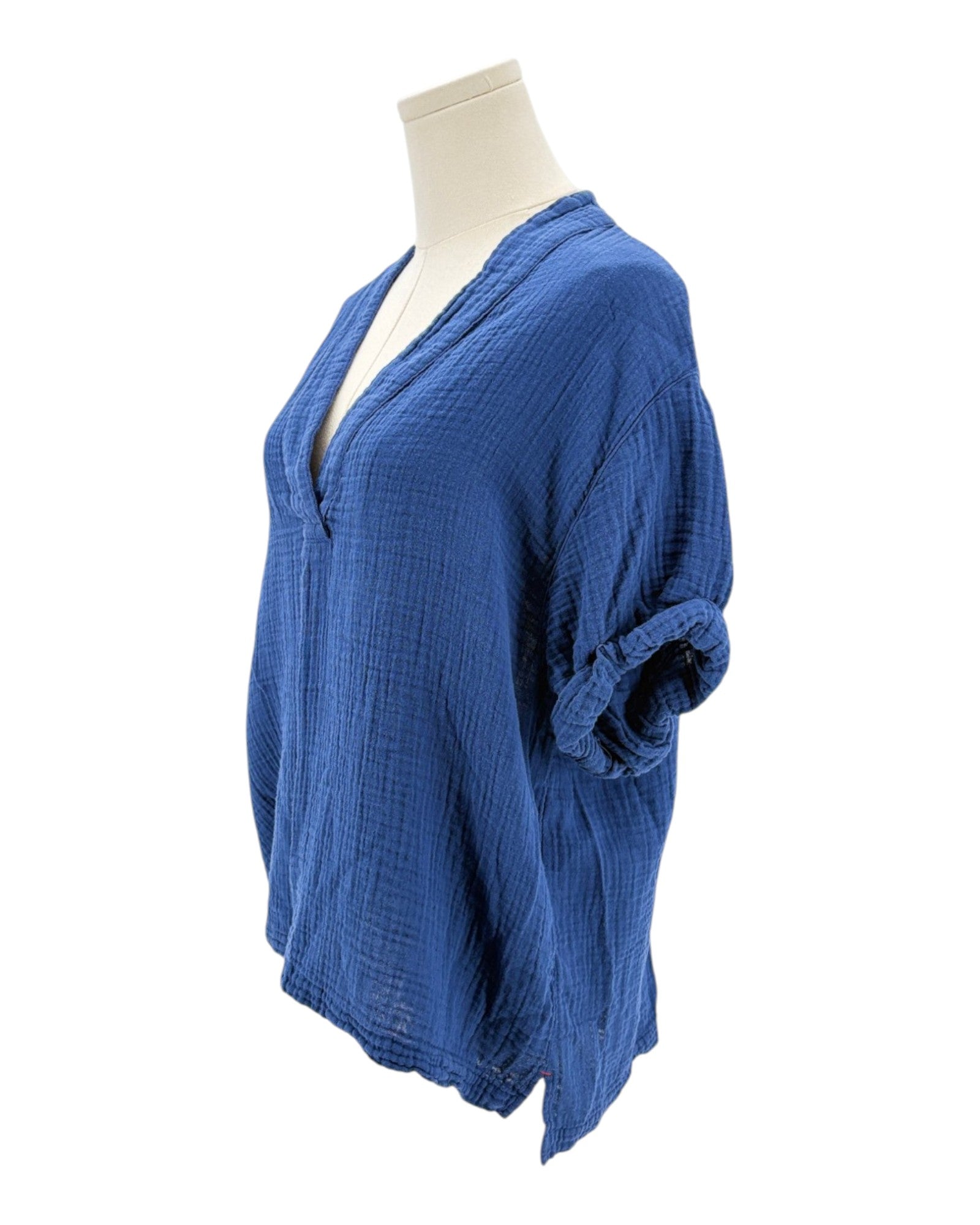 Blue textured blouse on a mannequin against a white background