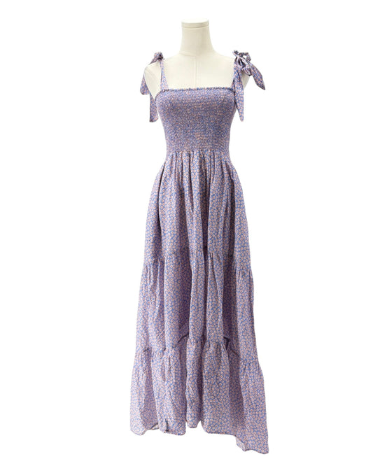 Purple floral dress on a mannequin against a white background