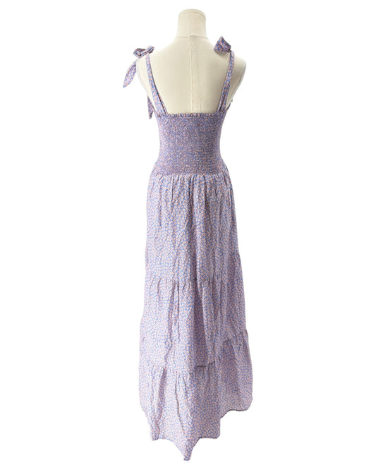 Purple tiered dress on a mannequin against a white background
