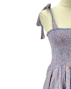Blue floral dress on a mannequin with a white background
