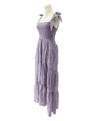 Purple dress on a mannequin against a white background