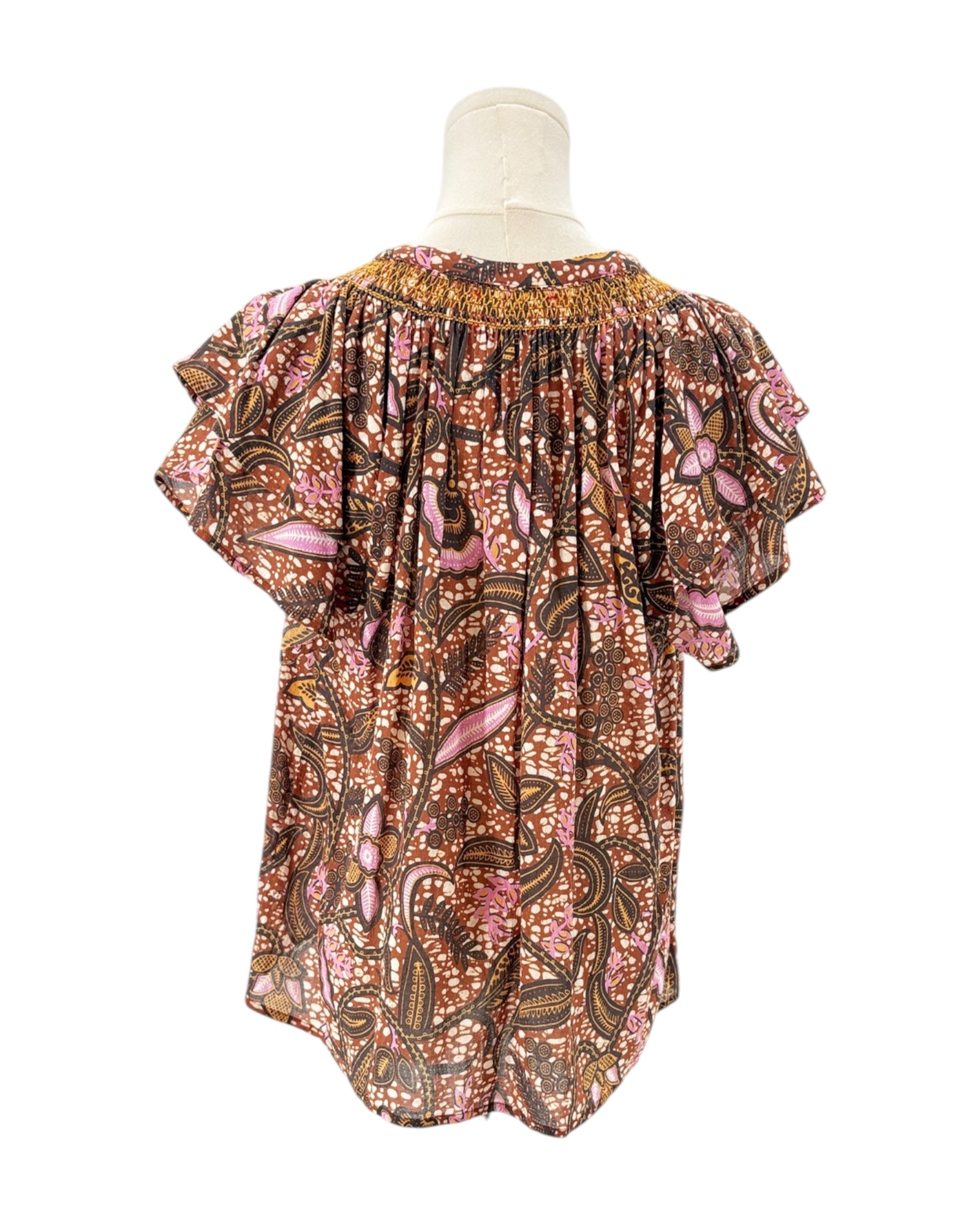 Xirena floral patterned blouse on a mannequin against a white background