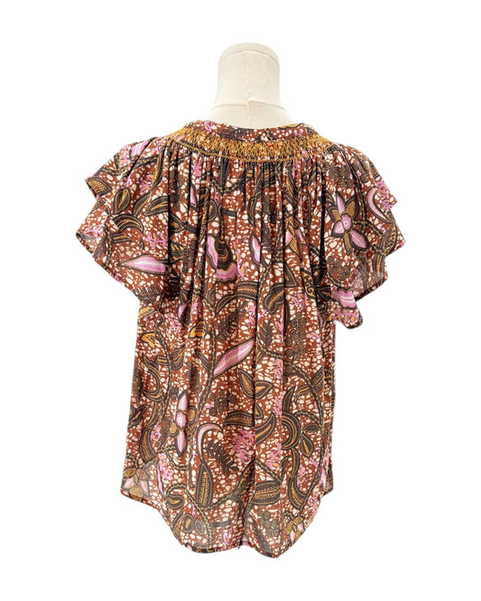 Xirena floral patterned blouse on a mannequin against a white background