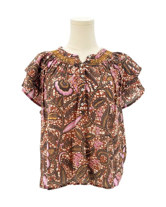 Xirena floral patterned blouse on a mannequin against a white background