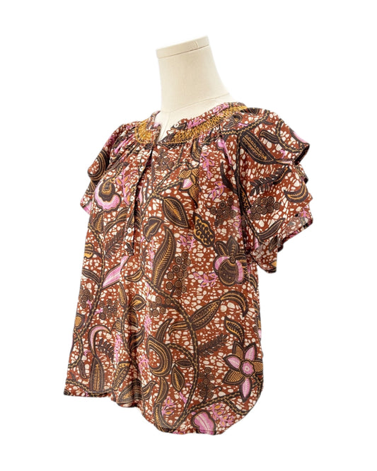 Xirena floral patterned blouse on a mannequin against a white background
