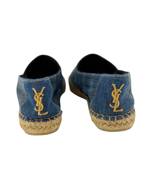 Pair of denim shoes with a logo on a white background